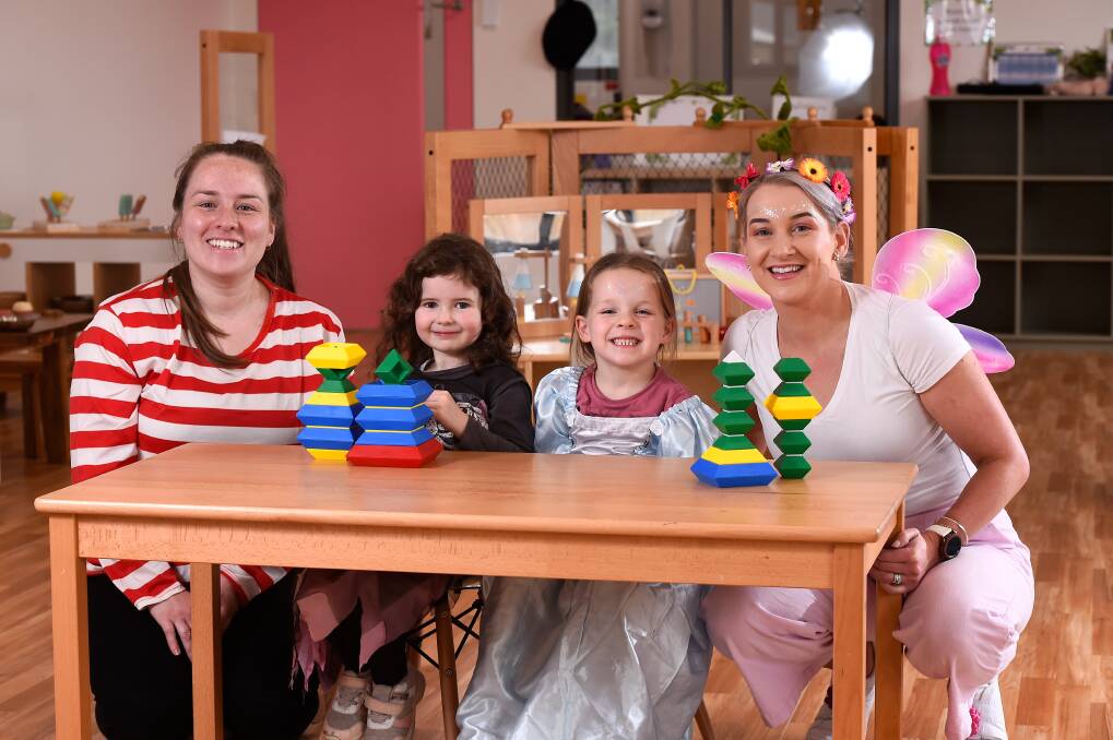 CHILDCARE: Brady Bunch Early Learning centre assistant director Emma Poloski (left) and director Rachel Condon with Ava and Zoe in their book week costumes. Picture: Adam Trafford