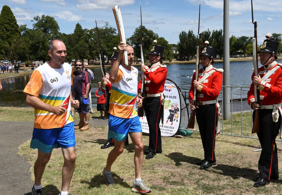 Peter Blackburn and Steve Moneghetti with the Queen's Baton at Lake Wendouree in 2018. Picture: Lachlan Bence