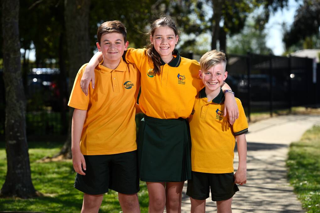 HAPPY: Alfredton Primary pupils Daniel, Chelsea and Jaxson enjoy making their own way to school as part of VicHealth's Walk to School month. Picture: Adam Trafford
