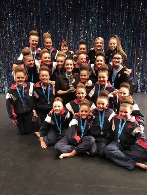 CHAMPS: Members of the Sovereign Calisthenics junior team celebrate winning back-to-back state championships after their title win in Burwood last week. 