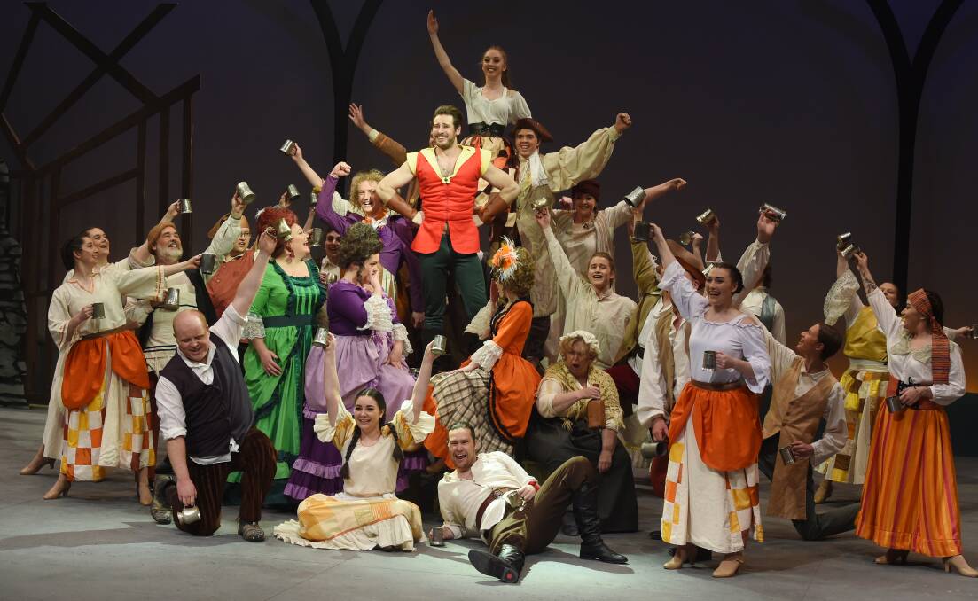 GROUP: The cast of the BLOC production of Beauty and the Beast raise their glasses in a toast during the show.