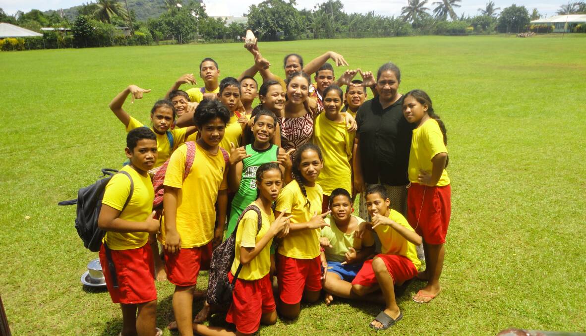 POPULAR: Tiarney Aiesi (centre) with pupils from Lalomanu Primary School in Samoa where she volunteers.