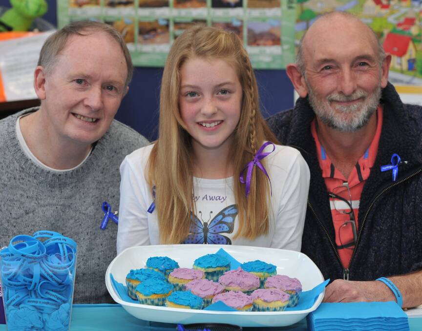 AWARENESS: During Huntington's Month last year Tiana, 10, helped raise awareness of the disease which affects her grandpa Bernie Collins, left, and great uncle Tim Collins. Picture: Lachlan Bence