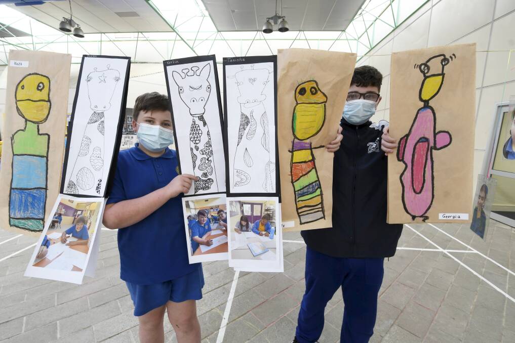 MASTERS: Sebastopol Primary pupils Korbin and Isaiah with artworks in the school's atrium, set up as a gallery with the creations posted as an online art show. Pictures: Lachlan Bence