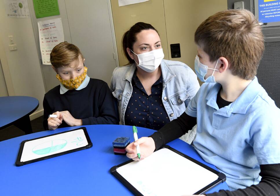 SUPPORT: Mount Egerton Primary School tutor Christine McShane works with students Nate and Lachlan. Picture: Lachlan Bence