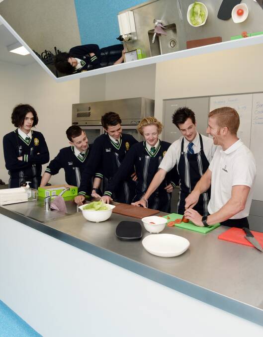 KITCHEN SKILLS: Future chefs Tom Marr, Kyle Faulkhead, Dylan York, Patrick Murphy and Zac Spark learn food preparation skills from LeRoy Hand. Picture: Kate Healy