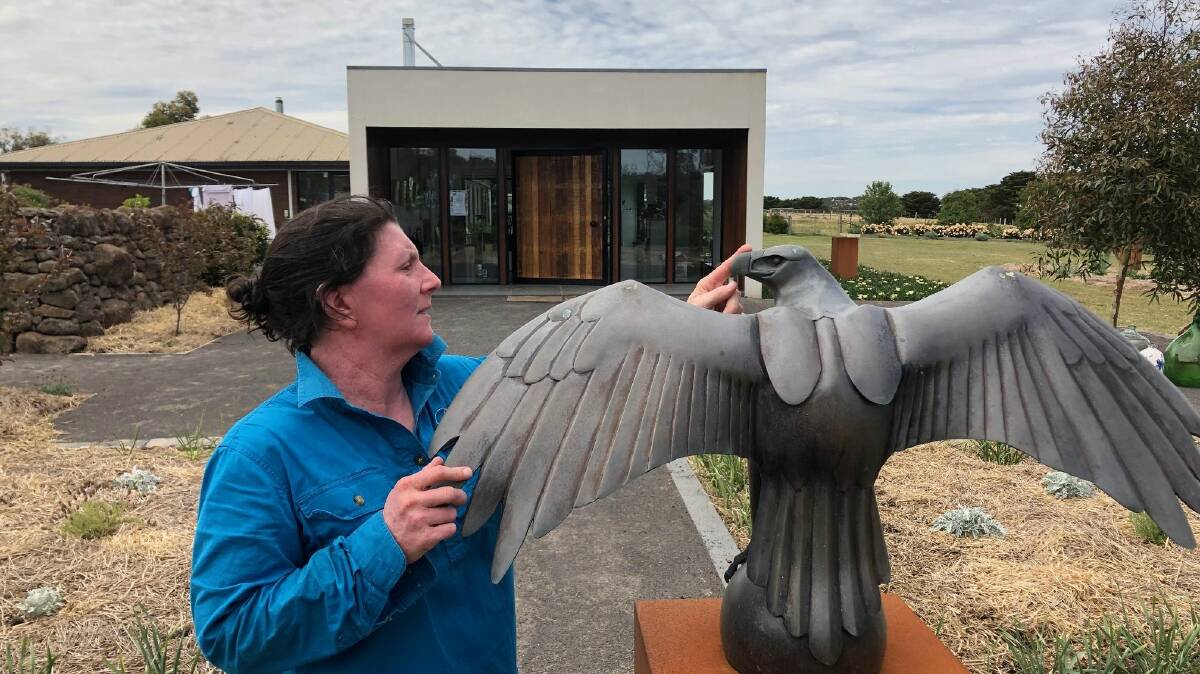 EAGLE: Gallery owner Lucy McEachern with Wedgetail Eagle outside her Wingeel gallery.