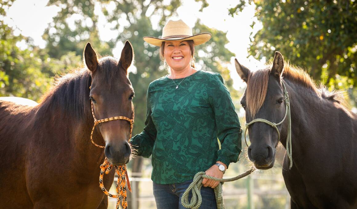 RESCUED: Leslie Scott with brumbies Lucy and Milo who she rescued after spending hours gaining their trust in the wild. Picture: Michelle Dunn Photography