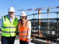 Grampians Health chief executive Dale Fraser and Victorian health minister Mary-Anne Thomas on top of the six-storey central energy plant building currently under construction as part of the Ballarat Base Hospital redevelopment. 
