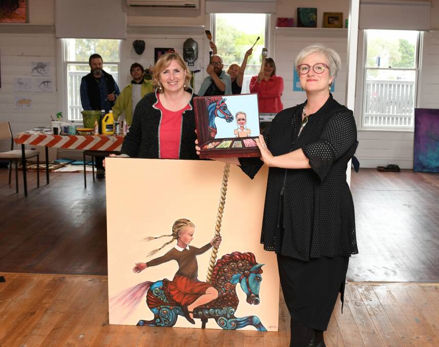 DONATION: Pinarc chief executive Marianne Hubbard and artist Stella Clarke with members of Pinarc's Turtle Art Group and two of the 10 artworks Ms Clarke has donated to the disability service. Picture: Lachlan Bence