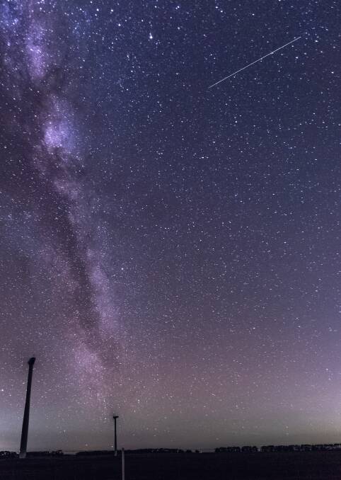 STREAK: An Eta Aquariid meteor streaks toward the Milky Way in the skies over the Mount Mercer Wind Farm just after 4am on Tuesday. Picture: Randal Smith