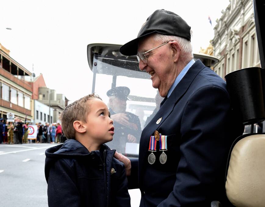 ANNIVERSARY: Oscar Kosloff and Tom Rush during the Anzac Day march in 2017 - a year to the day after their initial meeting. Picture: Lachlan Bence