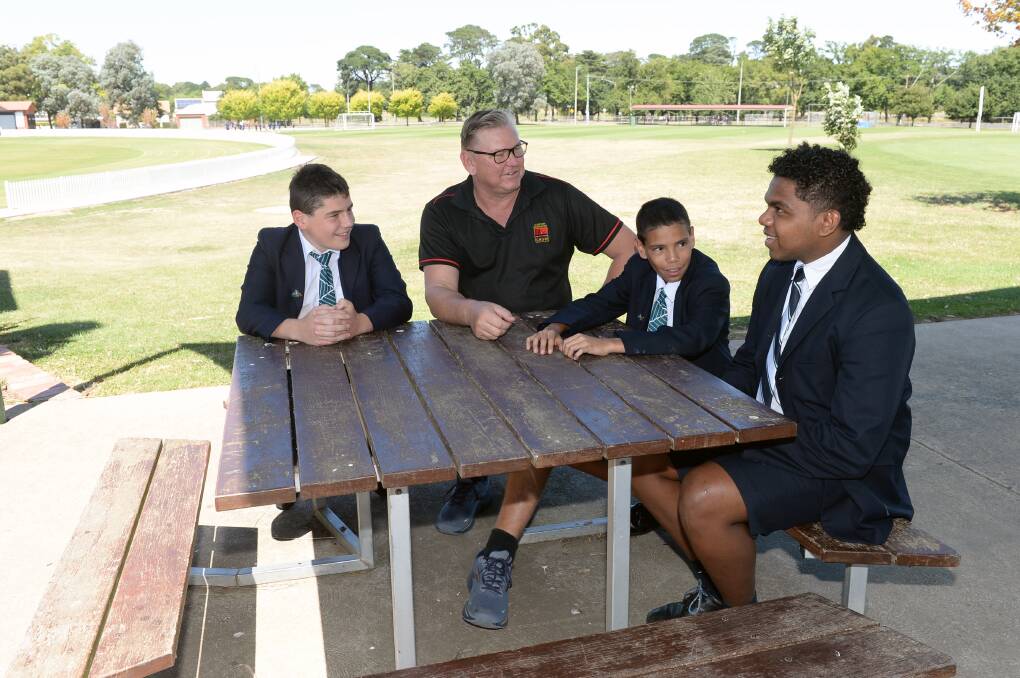 Laine Scott, St Patrick's Clotarf Academy director Dave Friebel, Marc Tedcastle and Cobain Tipiloura chat about their school day. Picture by Kate Healy