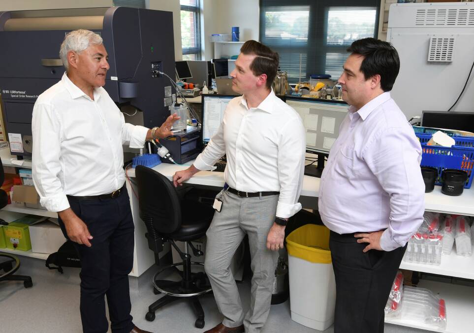 PARTNERS: FECRI director Professor George Kannourakis discusses the institute's cancer research projects with Lake Imaging's Dr Stefan Khosh and Dan Hilbert after the two organisations became official partners. Picture: Lachlan Bence