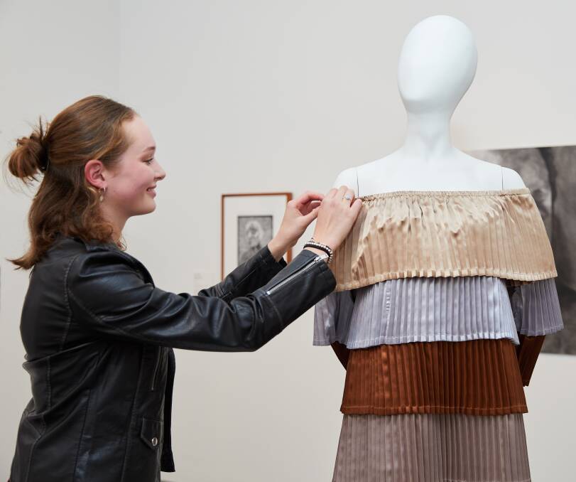 EXHIBIT: Ballarat Grammar student Eliza Griffin makes some adjustments to her VCE textiles project at the opening of the 2018 Top Arts exhibition at the National Gallery of Victoria - Australia at Federation Square