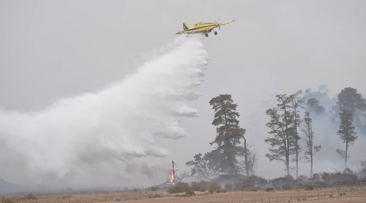 FIREFIGHT: Water bombers douse the Bunkers Hill grassfire in March 2019. Picture: Kate Healy