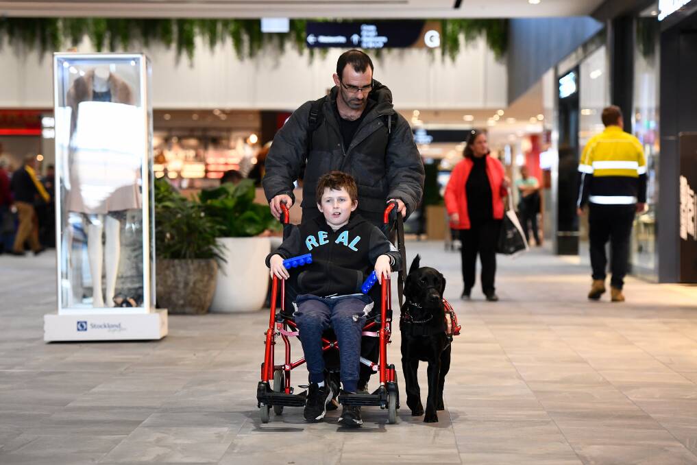 LEARNING: Kayle and his stepdad Daryl Hughnan walk along the corridors of Stockland Wendouree as part of their public access training. Picture: Adam Trafford