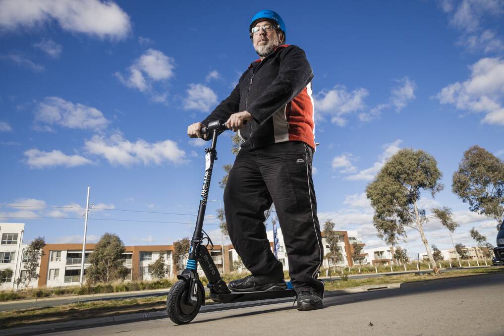 WHEELS: David Cook with an e-scooter. Picture: Sitthixay Ditthavong/Canberra Times