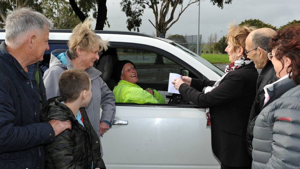 WIN: Cardigan Village residents congratulate Lyn McNeight on her reappointment during her mail delivery round on Thursday. Picture: Lachlan Bence