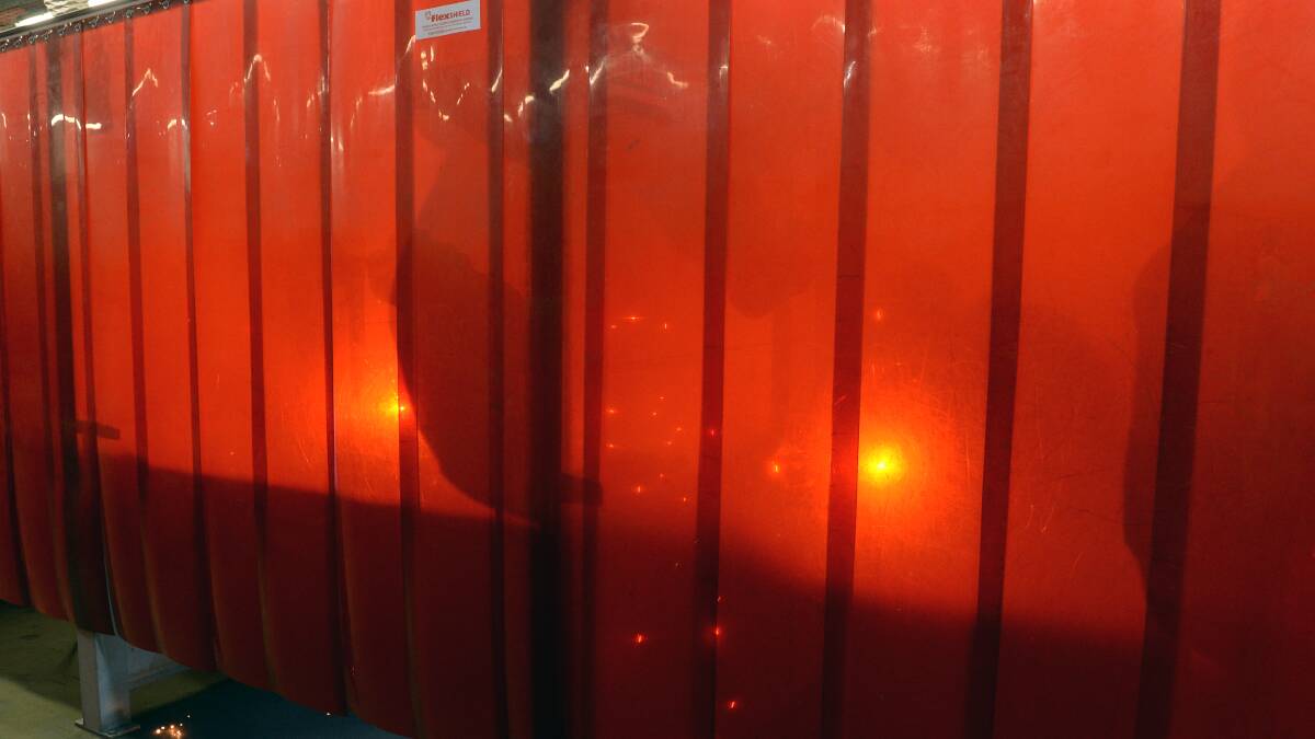 GLOW: Welding students practice their skills behind safety curtains at Federation University TAFE. Picture: Kate Healy 