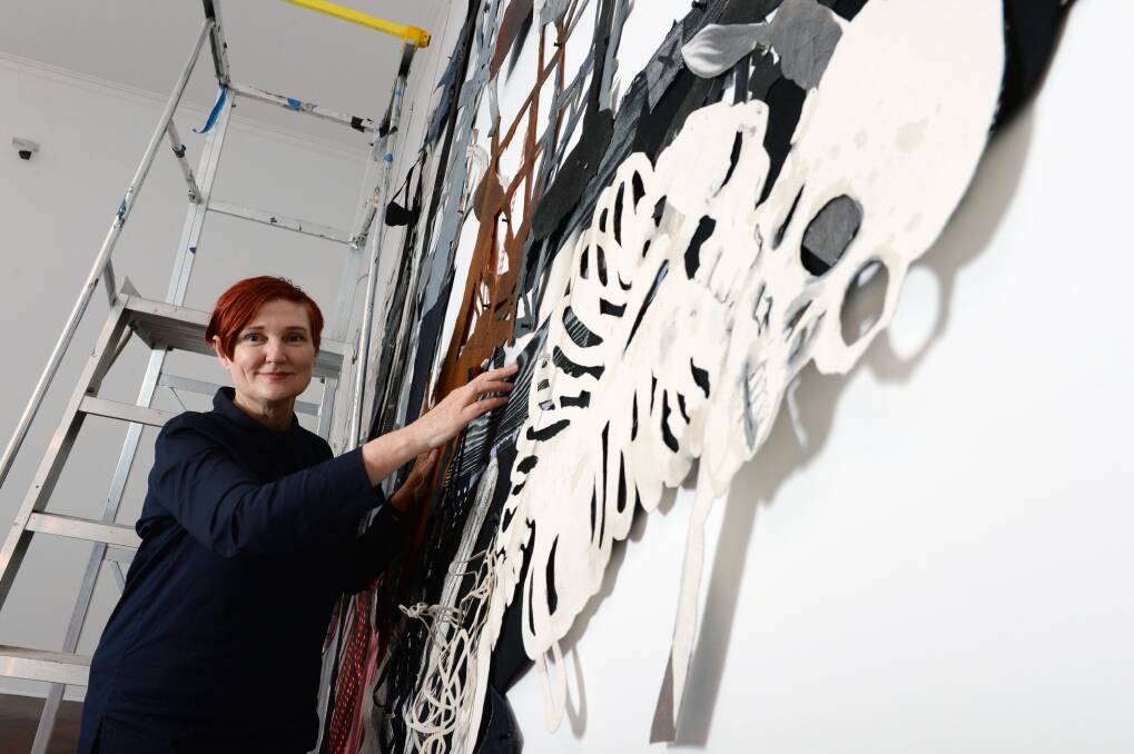 PIRATES AHOY: Sally Smart installs her 8m x 4m pirate ship artwork for the art gallery's Romancing the Skull exhibition. Picture: Kate Healy