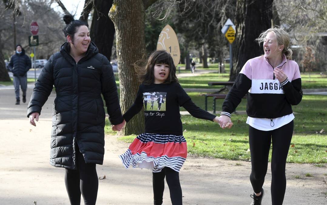 STEPPING OUT: Bree Pellow, Skye Robson, 11, and Teghan Henderson take a walk at the Lake ahead of Steps for Skye in August. Picture: Lachlan Bence
