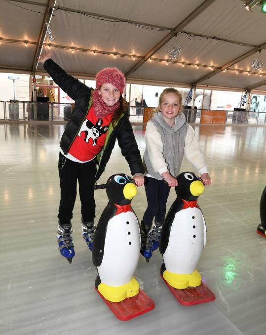 ICY: Macy Burrows, 10, and Florrence Burrows, 7, test out the ice of the Winter Festival pop-up ice skating rink in Armstrong Street South. Picture: Lachlan Bence