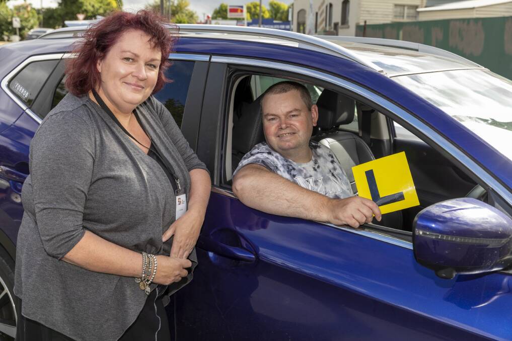 WHEELS: John Bartlett and support worker Lorelle Roslyn after Mr Bartlett passed his learner's permit test. Picture: supplied