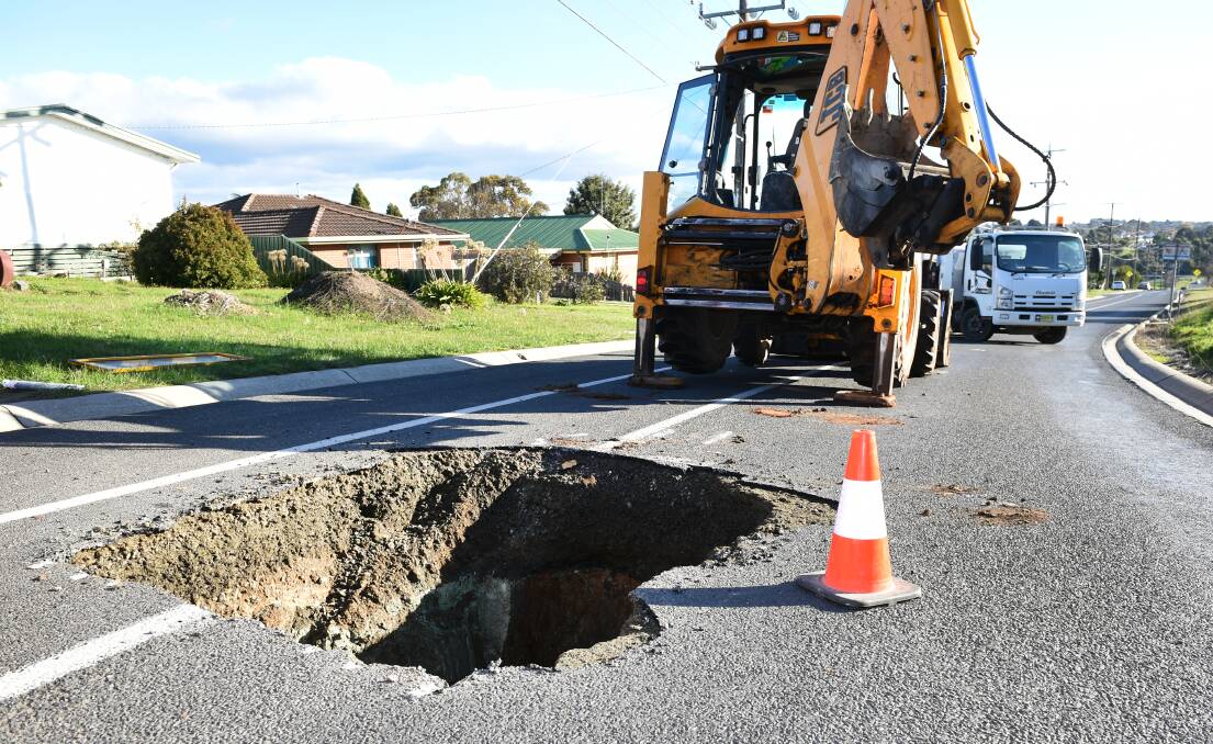 SUNK: Road crews tackle the first stage of repairing a sinkhole that opened up in Elsworth St West at Mt Pleasant. It is believed the hole resulted from ground movement around a goldrush-era ventilation shaft. Picture: Kate Healy