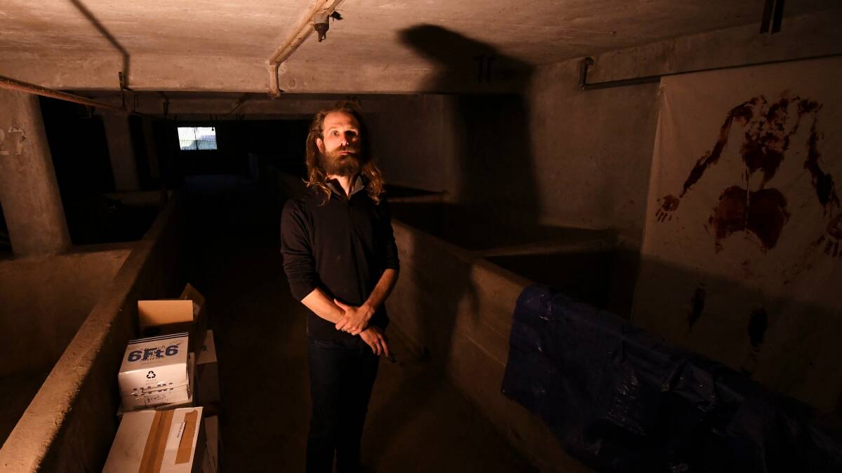 UNDERGROUND: Artist Ryan Kennedy in his basement space at the George Farmer Building. Picture: Lachlan Bence