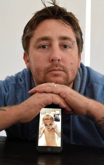 CONTACT: Brenton Butterworth has been facetiming his wife and baby daughter while caring for his three older children at home in Ballarat. Picture: Lachlan Bence