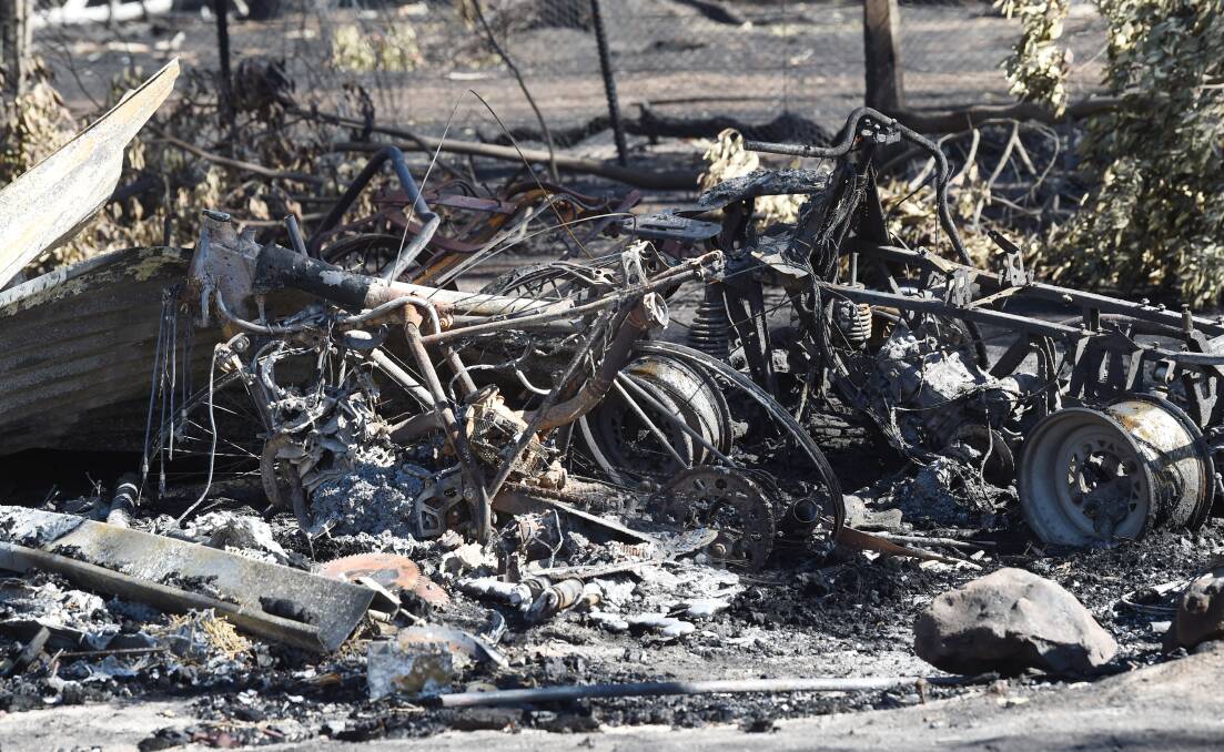 BLACKENED: The charred remains of the contents of one of the sheds destroyed on the Dowers' family property at Bunkers Hill. Picture: Kate Healy