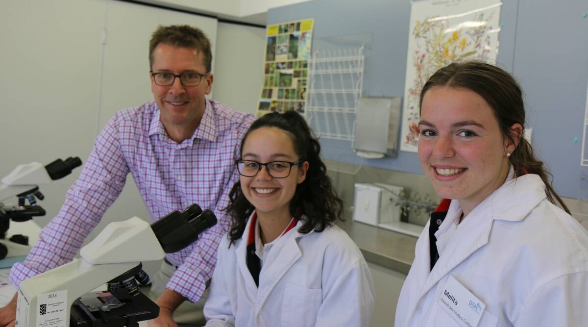 LEARNING: FECRI and Fed Uni immunologist Professor Stuart Berzins with secondary college students Tess Marrow and Melita Squire on International Day of Immunology.