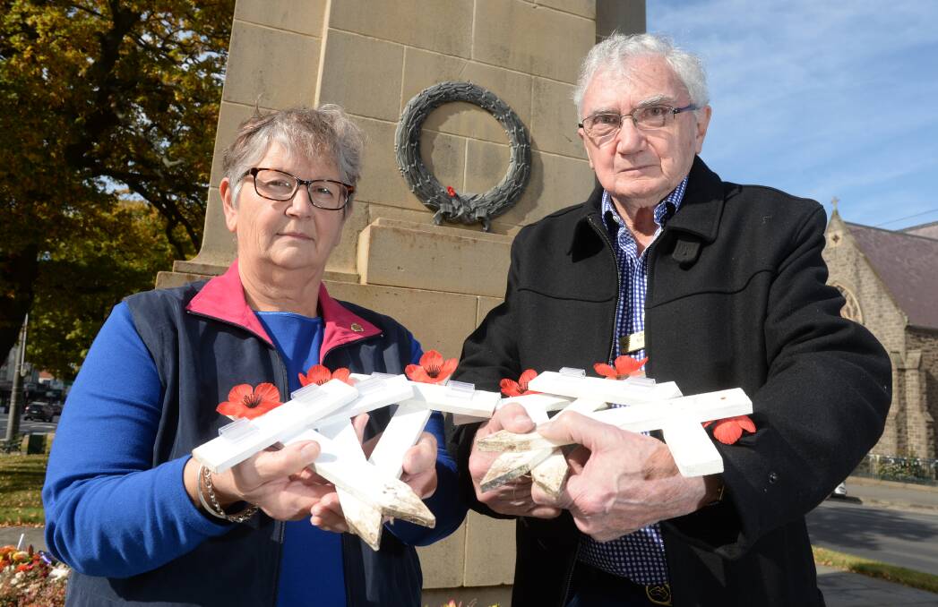 Ballarat RSL's Alex Tascas and Maurie Keating with some of the 1700 white crosses that will be planted near the cenotaph ahead of Anzac Day.