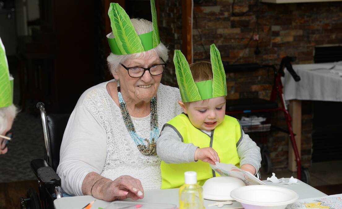 Helen Cox and Colt, 21 months, have fun doing Easter craft activities at BUPA Delacombe aged care. Picture by Kate Healy