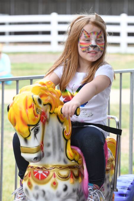 FUN DAY: With her face painted and enjoying a carousel ride, Evelyn Lambert, 4, from Mt Clear was one of about 2000 people to enjoy the annual Ballarat Health Services Christmas party at Burrumbeet racecourse. Picture: Kate Healy