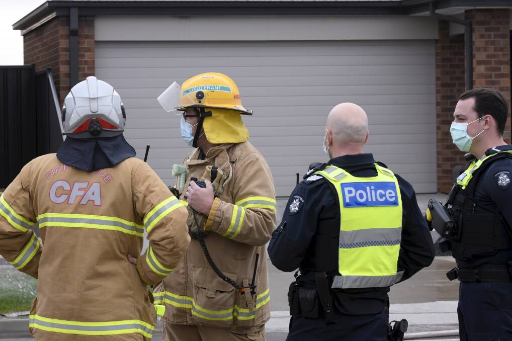 BLAZE: CFA officers and police at Sam Lehmann's home after it caught fire on August 11. Picture: Lachlan Bence