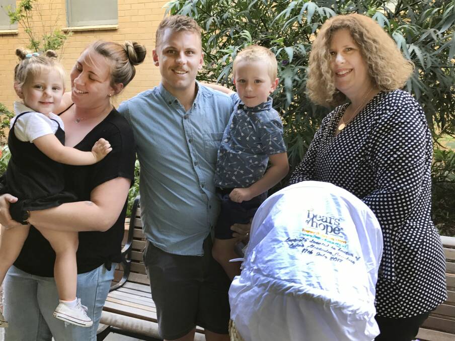 DONATION: Danielle and Josh Courtney holding Charlotte, 2, and Xavier, 4, with BHS director of maternity Carolyn Robertson and the $6000 cuddle cot donated in memory of their son Lucas, who was stillborn in July.