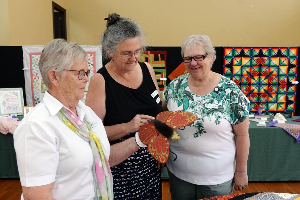 EMBROIDERY: Kirsty Beckett, Mary Jansen and Dianne Rasmanis from the Ballarat branch of the Embroiderers Guild of Victoria inspect the hand-made items on display. 
