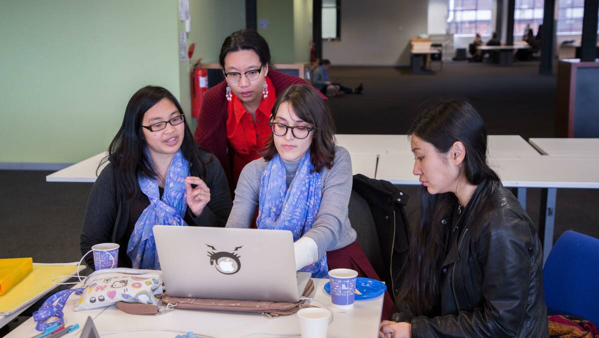 Women work on their project during a previous #SheHacks hackathon.