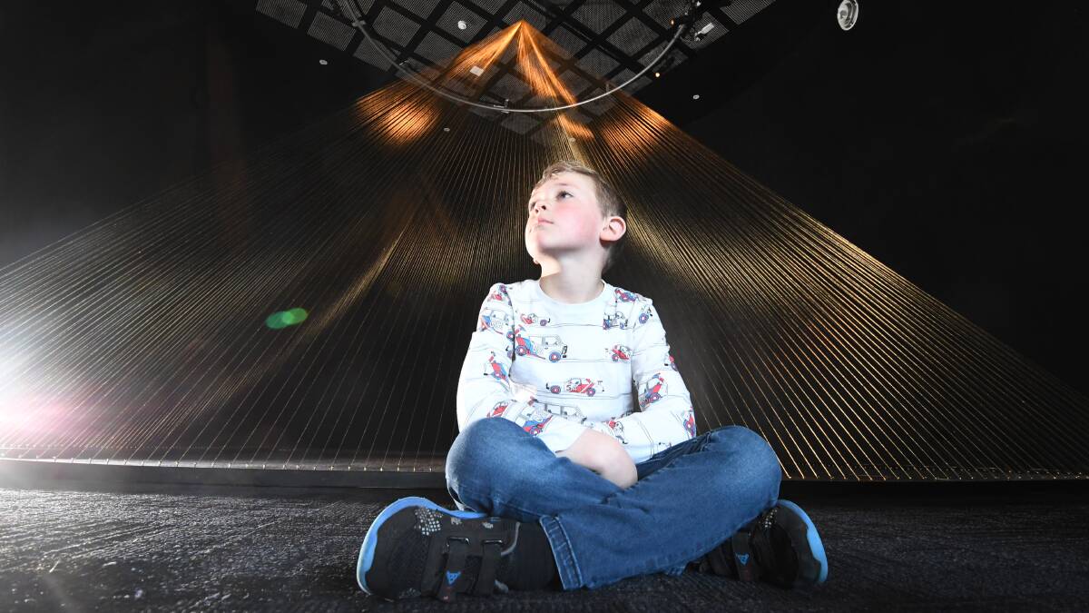 MORE BOAA: Flynn Sullivan, 6, gets a sneak peak at another BOAA show-stopper, a 5m pyramid created by Ken and Julia Yonetani from 24 carate gold thread. Picture: Lachlan Bence