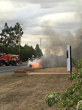 FIERY END: Three men crawled from the wreckage of their crumpled car as it burst in to flames following a fiery accident on Gillies Road in Mount Rowan on Monday.  