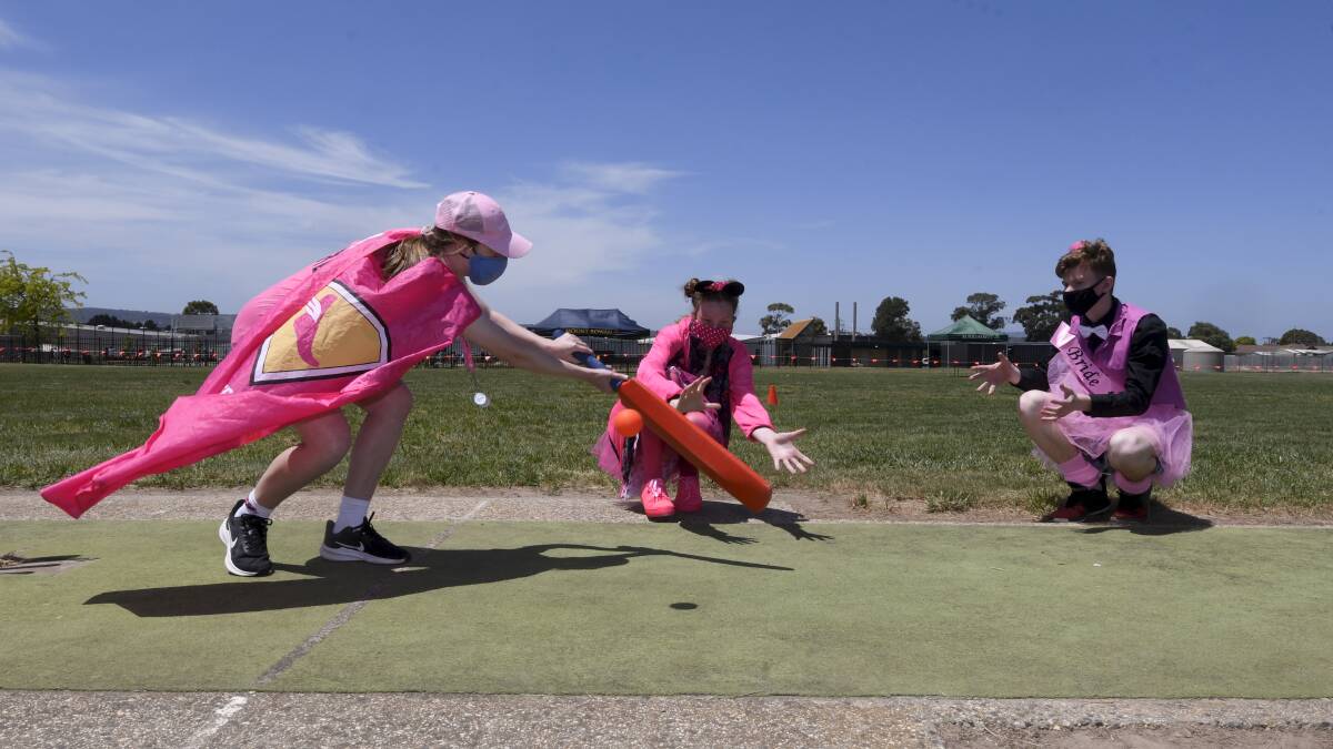 ACTION: Jasmine, Bridget and Cory get in to the action of a cricket match to support the McGrath Foundation's Pink Stumps Day. Picture: Lachlan Bence