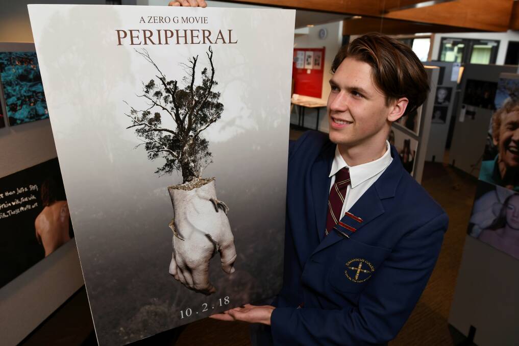 CREATIVE: Oscar Thomas with his art on display in the Damascus College Year 12 Visual Art Exhibition. Picture: Lachlan Bence