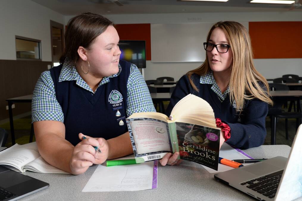 REVISION: Ballarat High School year 12 students Alla Sturgeon and Tamsyn Gladstone get in some extra study before Wednesday's VCE English exam, the first of six exams the pair will take on. Picture: Kate Healy