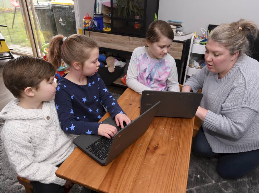 SCHOOL'S IN: Micah, 5, Ella, 7, Addison, 9, and mum Brooke Croton are all remote learning together at home. Picture: Lachlan Bence