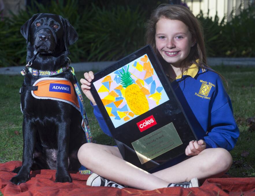 WINNER: Kassidy Jewell, with guide dog Willow, received a plaque featuring her design that will be printed on reusable bags at Coles. Her school, Woady Yaloak Primary School's Ross Creek campus, also received a $5000 grant to spend on a sustainability or environmental project. Picture: Mark Smith