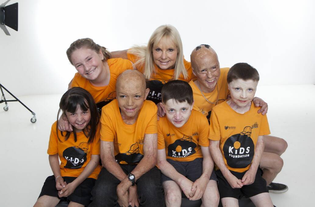 BELOW: Susie O'Neill with some of the children who are part of the extended KIDS Foundation family.