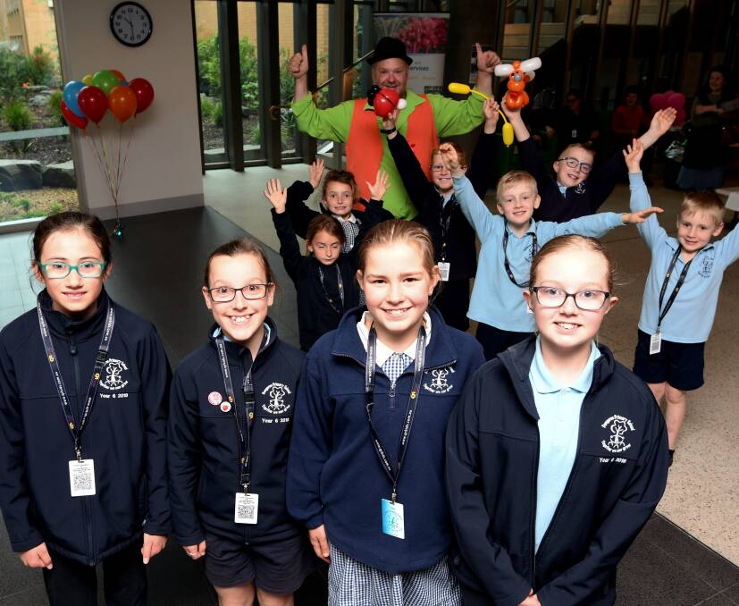 SPUDARAMA: Bungaree Primary School junior school councillors Ella, Holly, Claire and Tehya with their schoolmates at Ballarat Health Services where they donated $559 to BRICC which they raised from selling a tonne of potatoes. Picture: Lachlan Bence. 