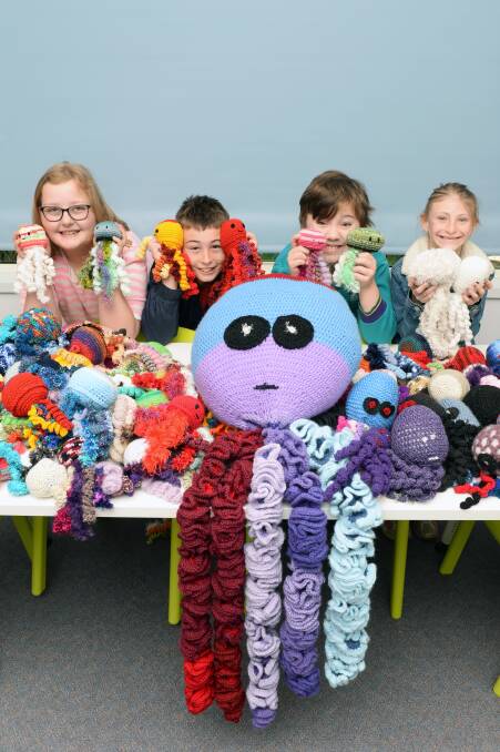 KNITTED FUN: Ballarat Specialist School grade five pupils Hayley, Aige, Cameron and Faith with the 101 octopuses donated for classroom lessons. Picture: Kate Healy